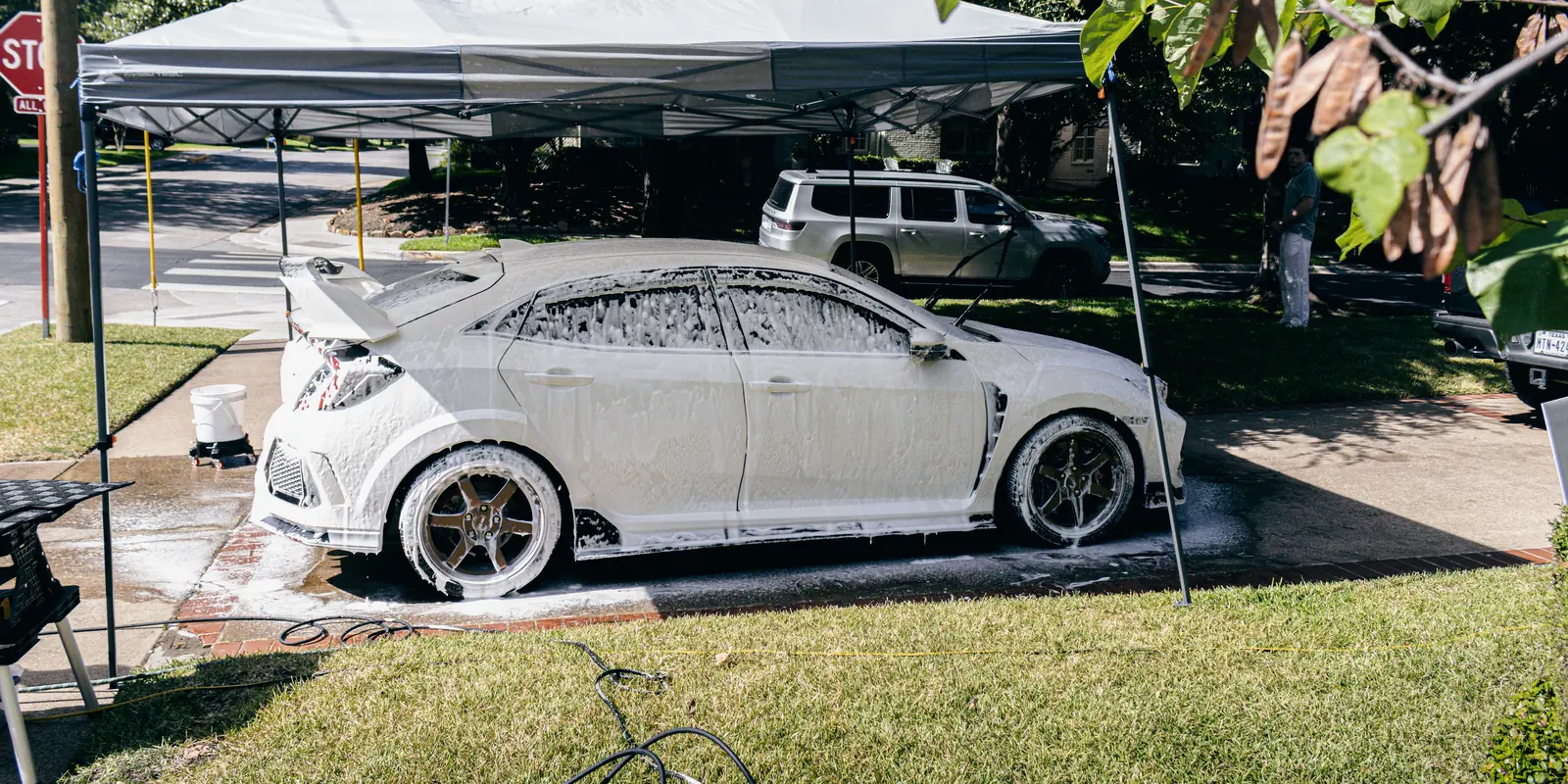 White Honda receiving a mobile detail in a McKinney driveway